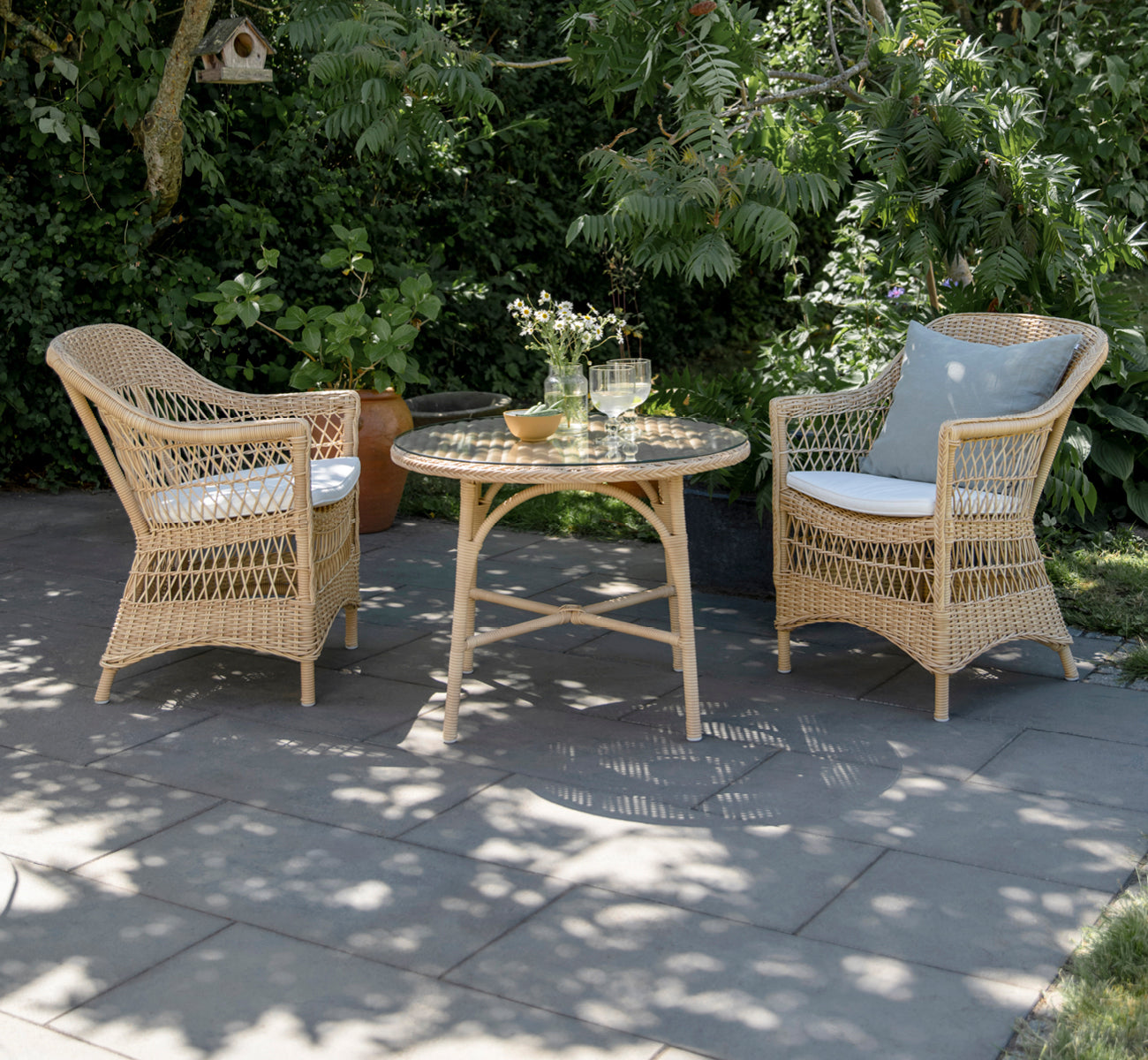 Dette er et livsstilsbillede af Victoria Exterior Coffee Table Ø80 cm i natural artfibre aluminium. Stylet i et lyst interiør.