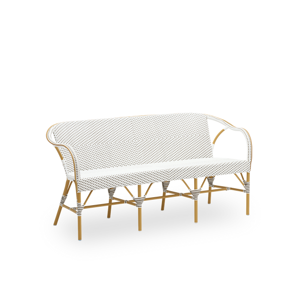 Sidevisning af Madeleine udendørs bænk, i mandelfarvet stel og hvid ArtFibre med cappuccino-prikker. Del af Alu-Affäire-kollektionen, inspireret af Sika-Designs egne designs fra 1950'erne og parisiske bistroer. Kan stå ude hele året.