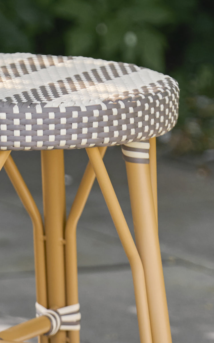 Dette er et nærbillede af Simone Udendørs skammel i almond aluminium frame striped cappuccino ivory artfibre.