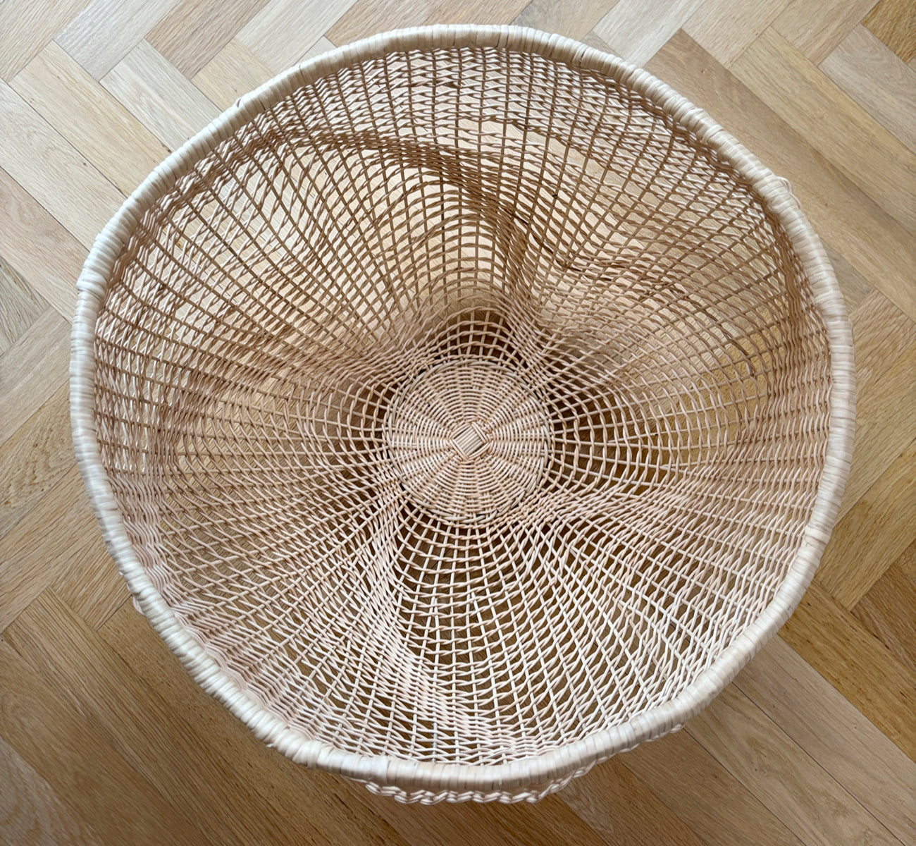 Dette er et livsstilsbillede af Folia Kurv i natural core weave iron frame, i et lyst hvidt interiør med lambrisering, stylet med tørrede blomster.